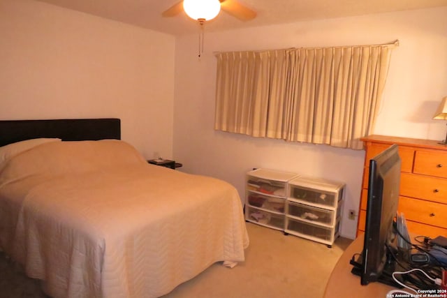 bedroom with light colored carpet and ceiling fan