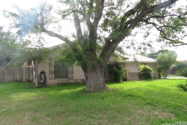 view of side of property with a lawn