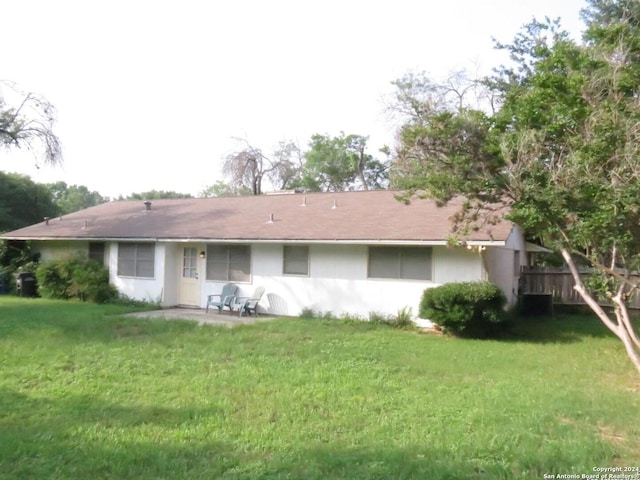 rear view of house with a yard and a patio