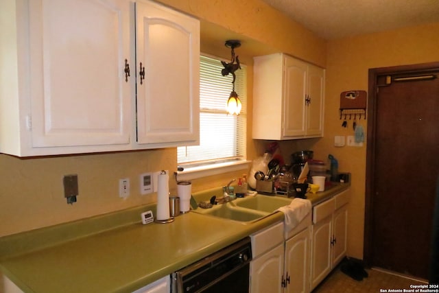 kitchen featuring pendant lighting, white cabinetry, sink, and black dishwasher