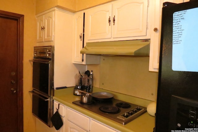 kitchen with black appliances and white cabinetry