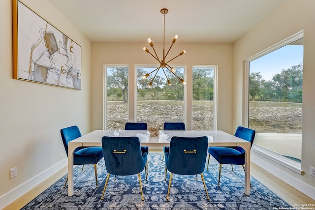 dining area featuring a notable chandelier and hardwood / wood-style floors