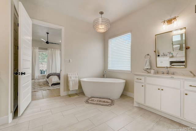 bathroom featuring tile floors, vanity, a washtub, and ceiling fan