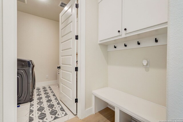 mudroom featuring light tile flooring and washer / clothes dryer