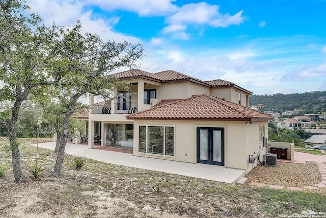 back of house featuring a patio area, central AC unit, and a balcony