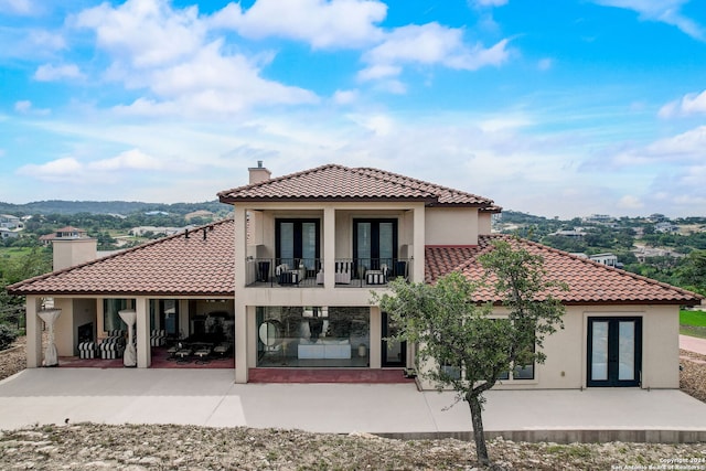 back of house featuring a patio and a balcony