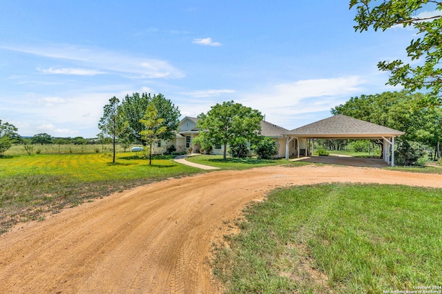 ranch-style home with a front yard and a carport