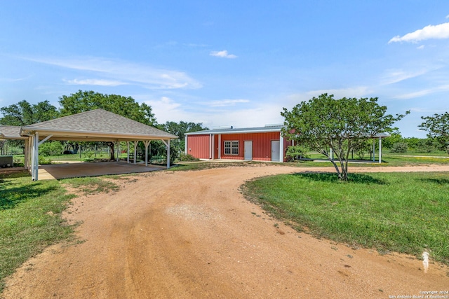 view of front facade with a front lawn and a carport