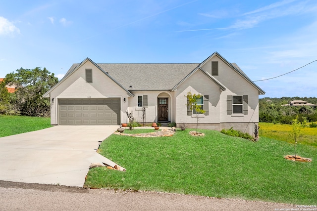 view of front of property featuring a garage and a front lawn