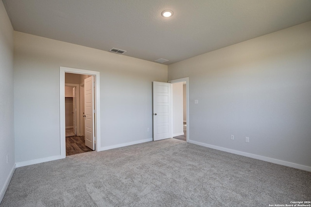 unfurnished bedroom with carpet flooring and a textured ceiling