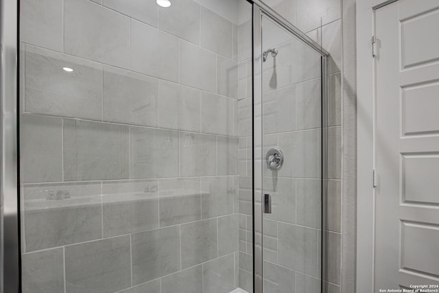 bathroom featuring a shower with shower door