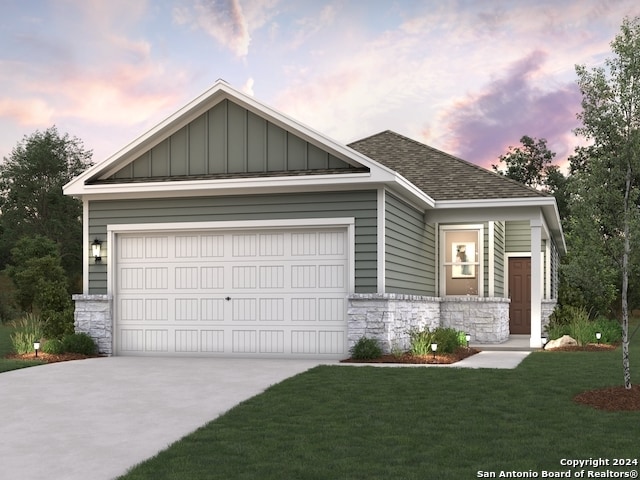 craftsman inspired home featuring a garage and a lawn