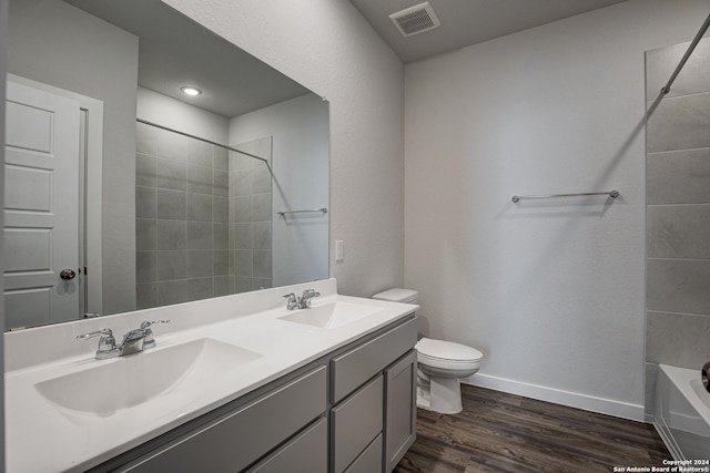 full bathroom with toilet, vanity, shower / bath combination, and wood-type flooring