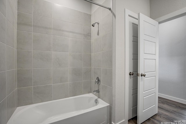 bathroom featuring hardwood / wood-style floors and tiled shower / bath