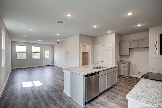 kitchen with sink, stainless steel appliances, gray cabinets, light stone countertops, and a kitchen island with sink