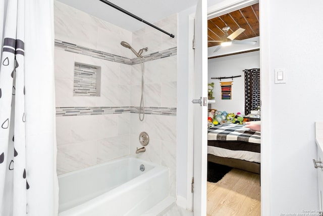 bathroom featuring hardwood / wood-style flooring and shower / bath combo with shower curtain