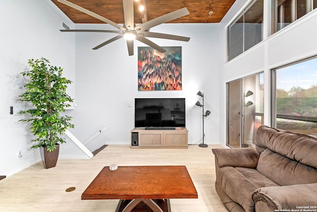 living room featuring wooden ceiling, a towering ceiling, hardwood / wood-style flooring, and ceiling fan