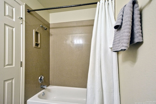 bathroom with shower / bath combo with shower curtain