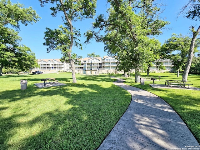 view of property's community with a lawn