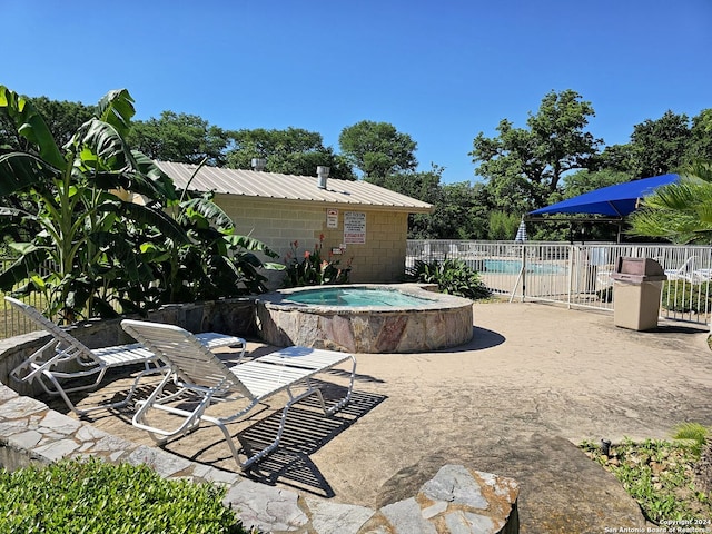 view of pool featuring an in ground hot tub and a patio area