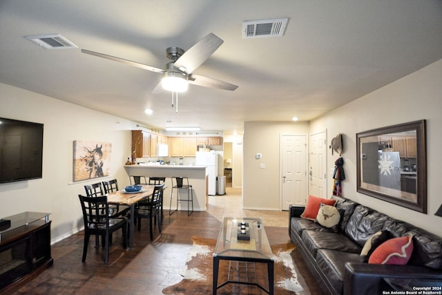 living room with ceiling fan and hardwood / wood-style floors