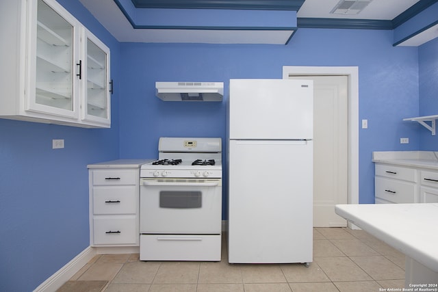 kitchen featuring white cabinets, light tile flooring, and white appliances