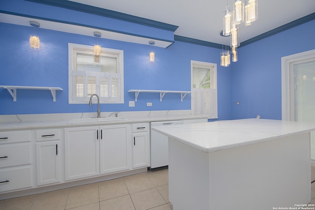 kitchen featuring white dishwasher, sink, a kitchen island, and pendant lighting