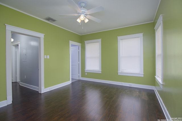 empty room featuring ornamental molding, wood-type flooring, and ceiling fan