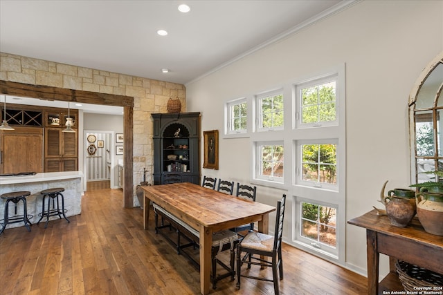 dining room featuring ornamental molding and dark hardwood / wood-style flooring