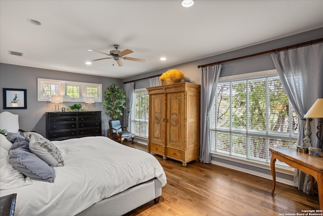 bedroom with ceiling fan and wood-type flooring