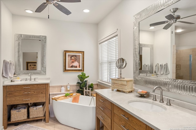 bathroom featuring tile flooring, ceiling fan, a bath to relax in, and vanity