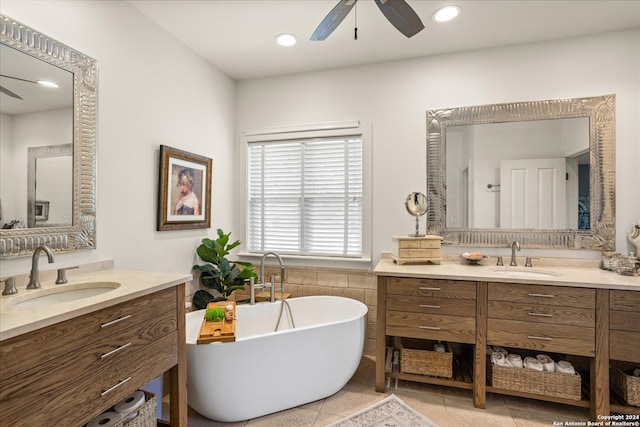 bathroom featuring tile flooring, dual vanity, ceiling fan, and a tub