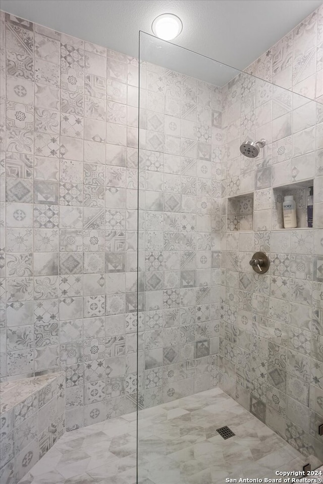 bathroom with tiled shower