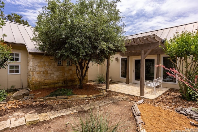 back of property with a pergola and a patio