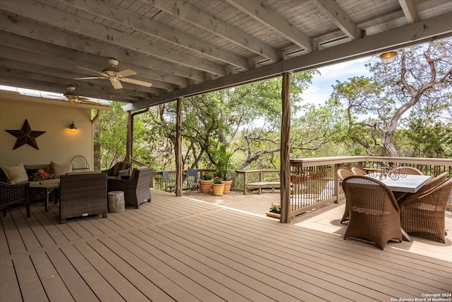 wooden deck with outdoor lounge area and ceiling fan