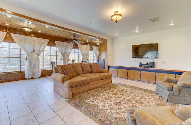 tiled living room with ceiling fan