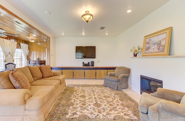 tiled living room featuring ceiling fan