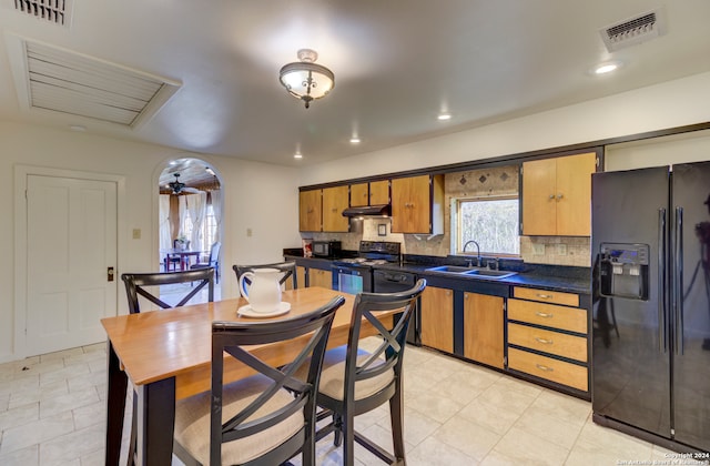 kitchen featuring black appliances, sink, backsplash, and light tile flooring