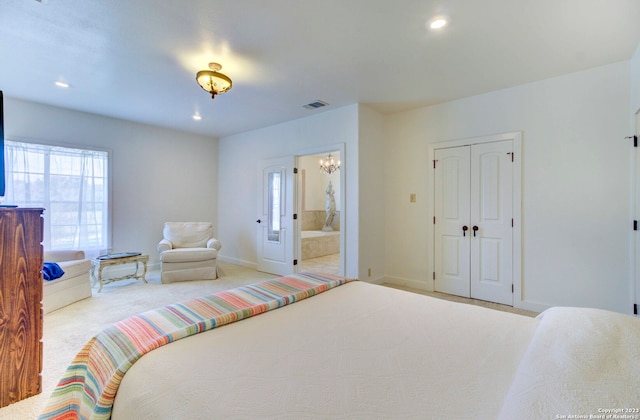 bedroom with carpet flooring, a closet, and connected bathroom