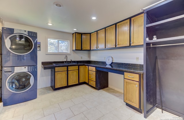 kitchen featuring stacked washer and dryer, sink, and light tile floors