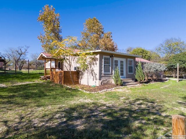 view of side of property with a lawn