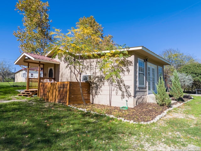 view of side of home featuring a lawn