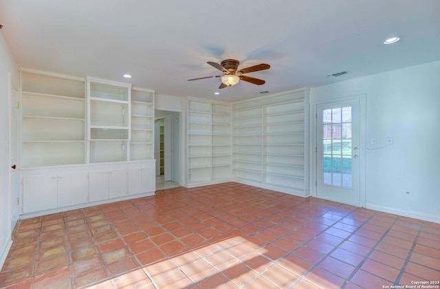 tiled spare room with built in shelves and ceiling fan