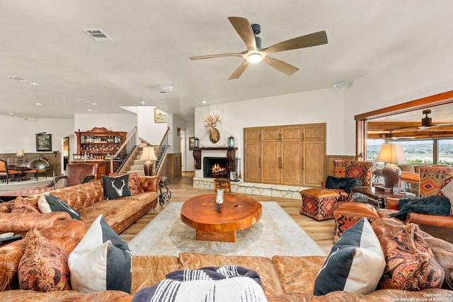 living room featuring ceiling fan and light hardwood / wood-style flooring