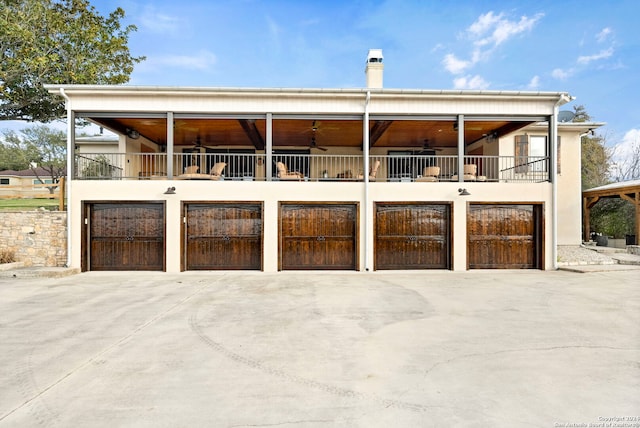 view of front of house featuring a balcony and ceiling fan