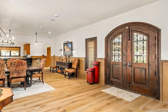 entrance foyer featuring plenty of natural light, light wood-type flooring, and a chandelier