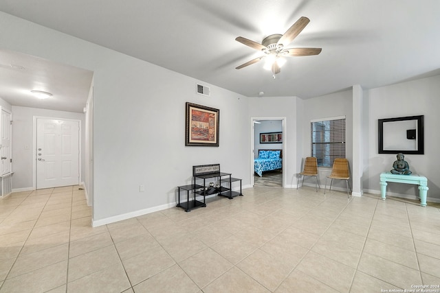 living room featuring ceiling fan and light tile floors