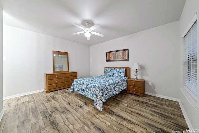 bedroom with ceiling fan and hardwood / wood-style flooring