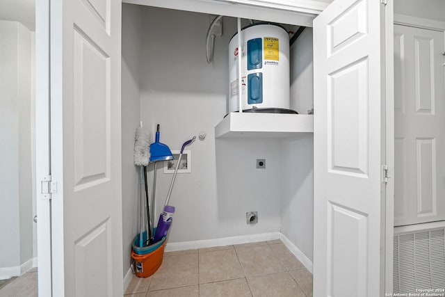 clothes washing area with light tile floors, water heater, and electric dryer hookup