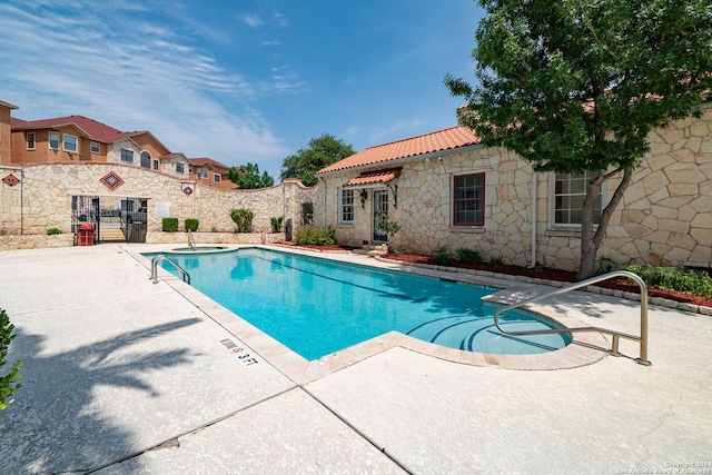 view of swimming pool featuring a patio area